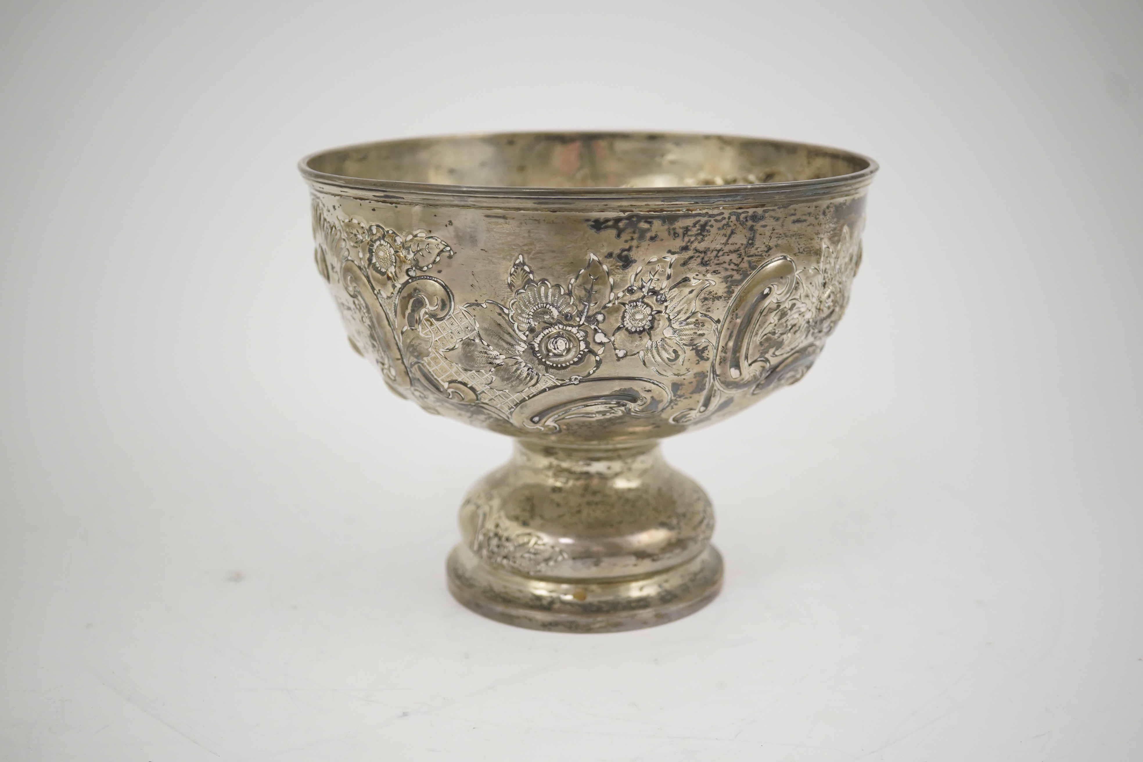 A George V repousse silver pedestal rose bowl, by Carrington & Co